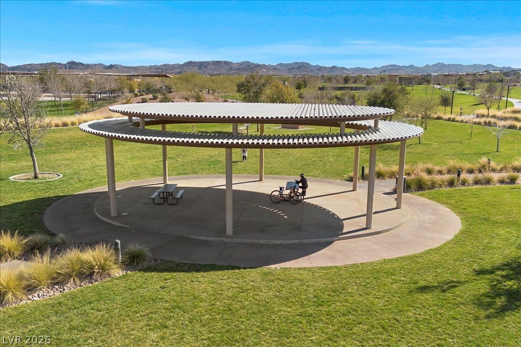 320 Della Pergola Place, Henderson, NV 89015 A spacious covered pavilion sits amidst grassy park fields with distant mountain views.