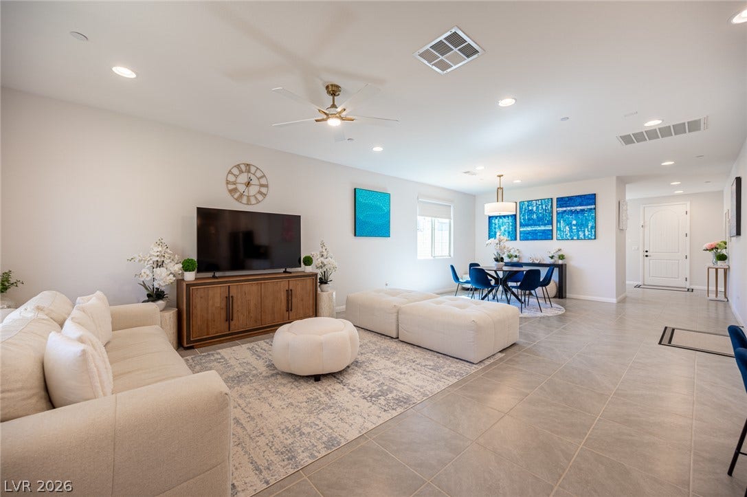 320 Della Pergola Place, Henderson, NV 89015 An open layout connects the living and dining spaces over continuous tile flooring.