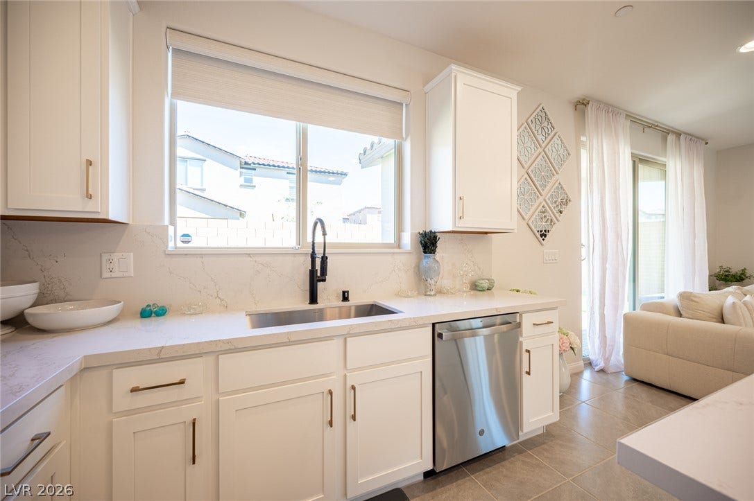 320 Della Pergola Place, Henderson, NV 89015 Bright stone countertops complement clean cabinetry in this airy kitchen workspace.