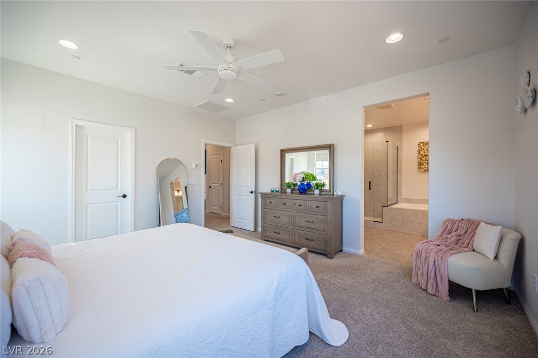 320 Della Pergola Place, Henderson, NV 89015 Plush carpeting and an open archway leading to the en suite bath define this bedroom.