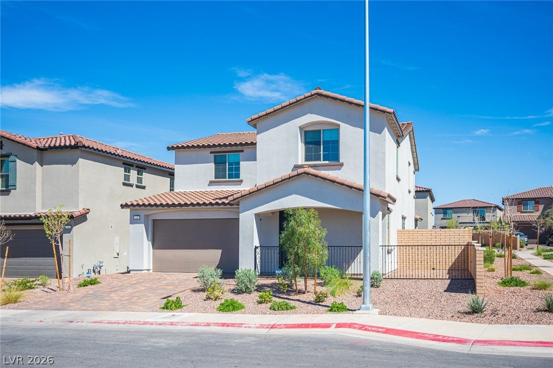 320 Della Pergola Place, Henderson, NV 89015 Spanish tile roofing and a paved driveway enhance this modern two-story home's exterior.