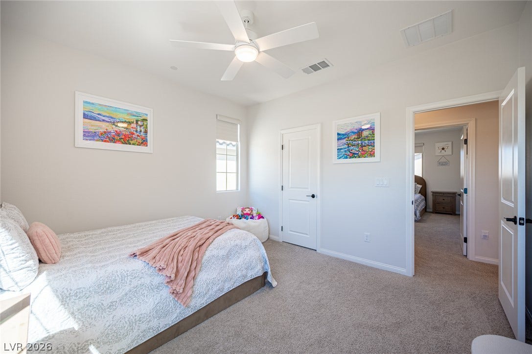 320 Della Pergola Place, Henderson, NV 89015 Plush carpeting and crisp white trim enhance this comfortable bedroom layout.