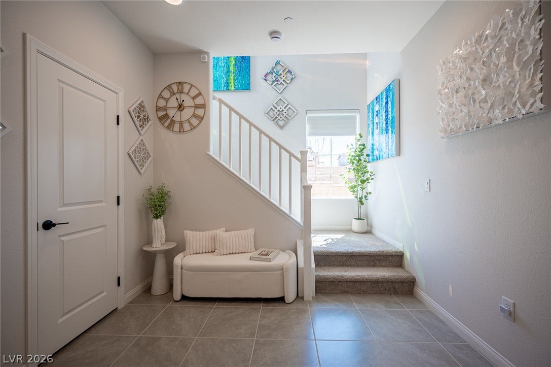 320 Della Pergola Place, Henderson, NV 89015 An inviting entrance foyer welcomes guests with modern tile flooring and a carpeted staircase.