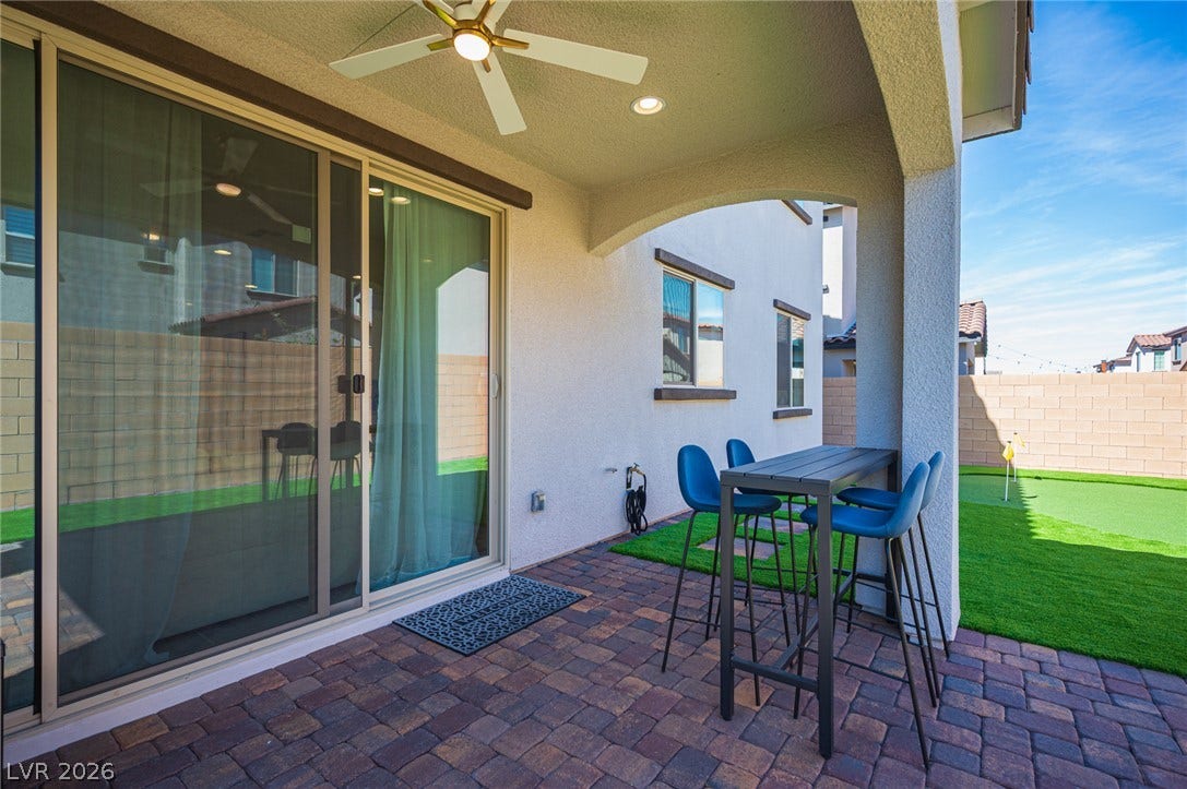 320 Della Pergola Place, Henderson, NV 89015 A covered patio with brick pavers connects seamlessly to the private backyard.