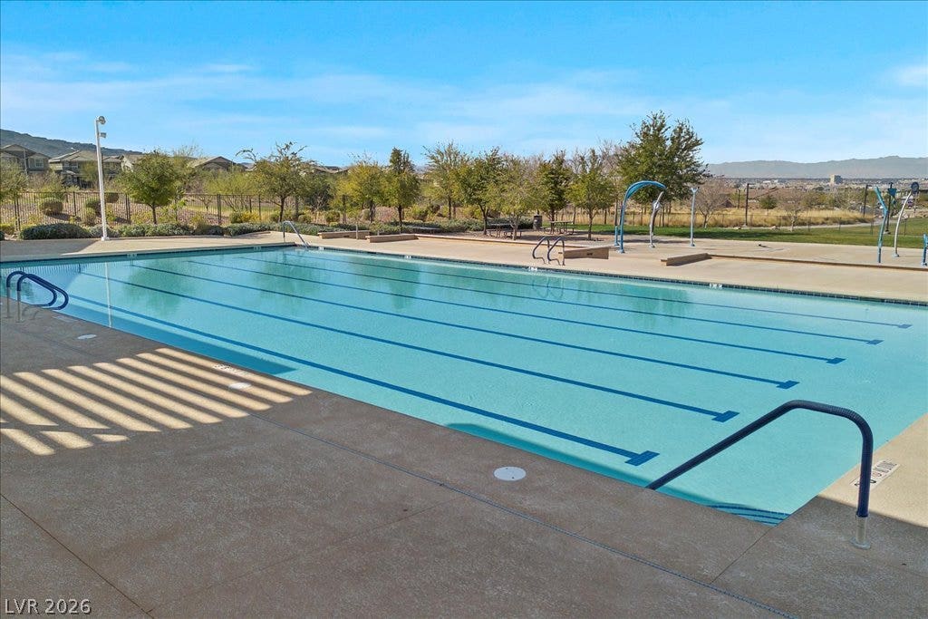 320 Della Pergola Place, Henderson, NV 89015 A spacious outdoor lap pool overlooks the surrounding landscape under clear skies.