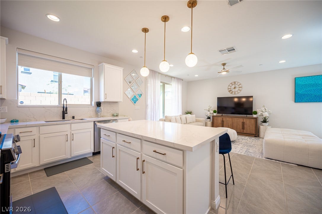 320 Della Pergola Place, Henderson, NV 89015 An open floor plan connects the modern kitchen directly to the bright living area.