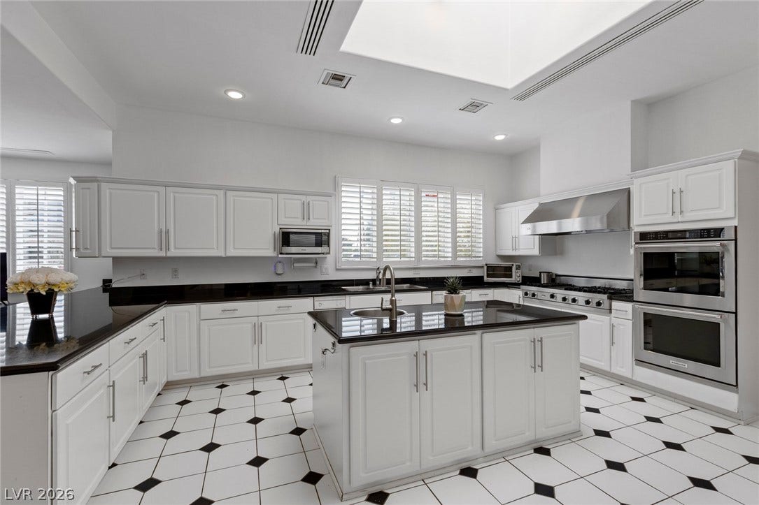 Natural light pours through a large skylight over the central island in this spacious kitchen.