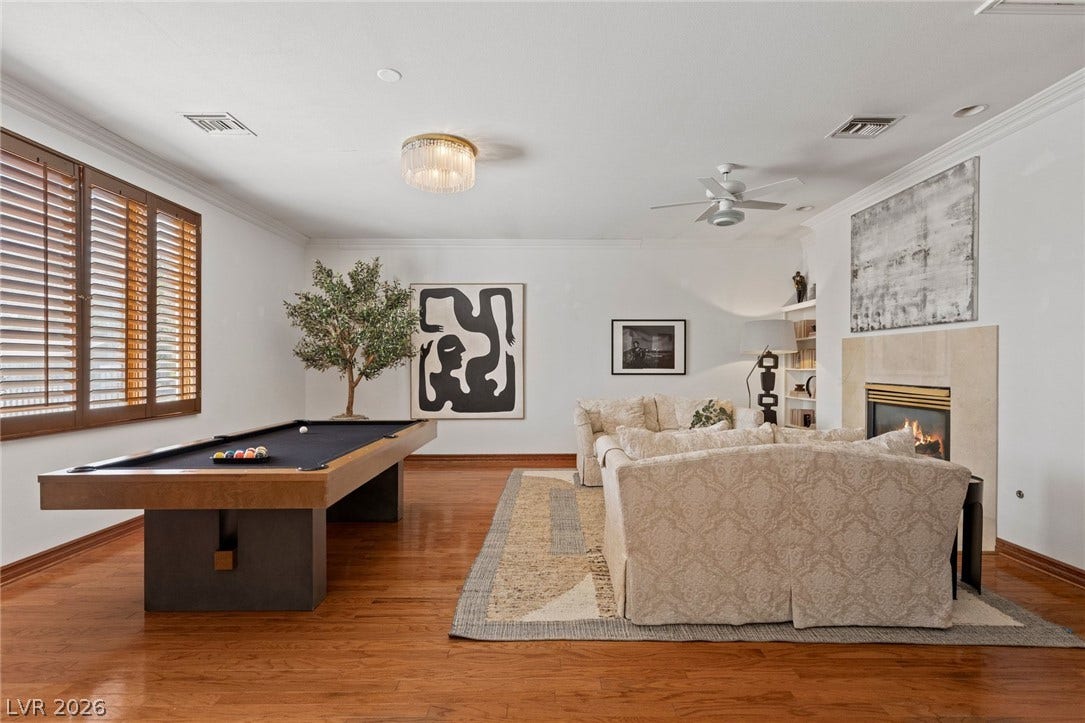 Gleaming hardwood floors and a warm fireplace define this spacious multi-functional living area.