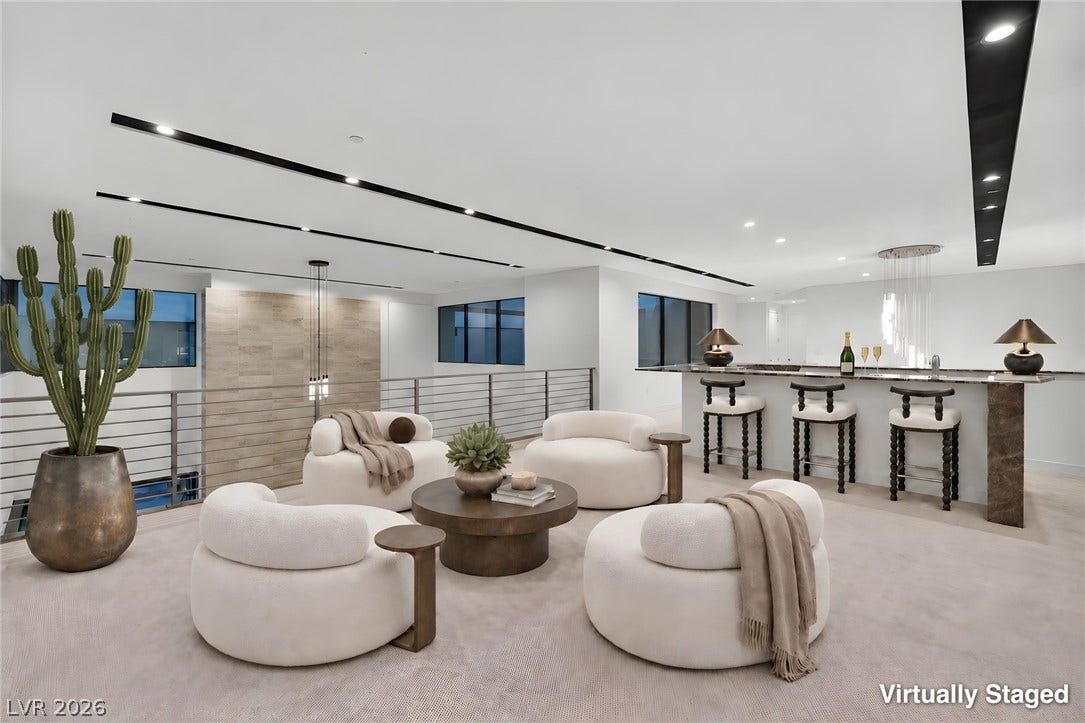 Recessed lighting accents this modern loft overlooking the lower level.