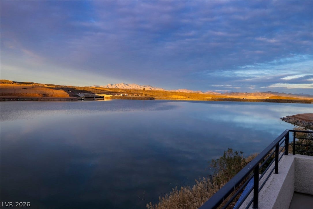 Gaze across still waters to distant mountains under a dramatic sky from this viewing point.