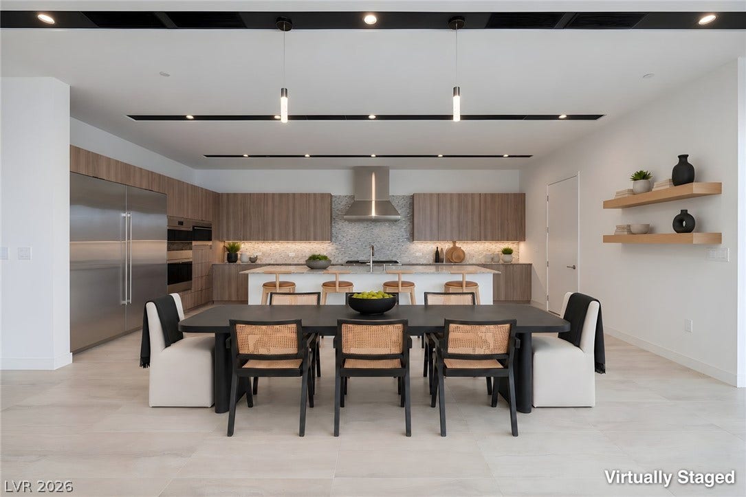 Seamless transition from dining space to a modern kitchen defined by clean architectural lines.