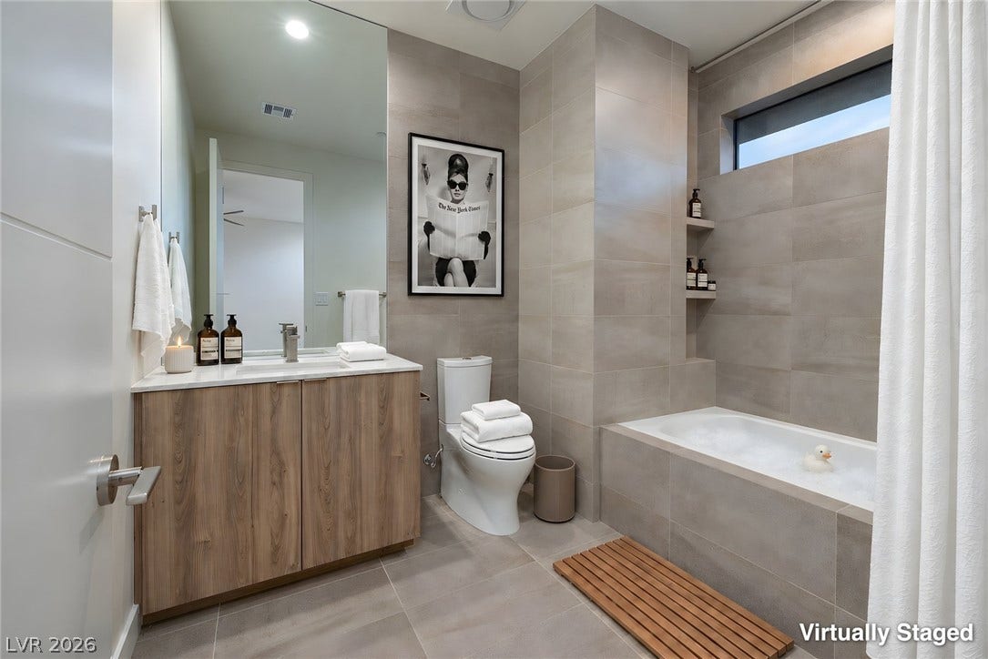 Large format tiling and clean architectural lines create a highly modern, functional bathroom design.