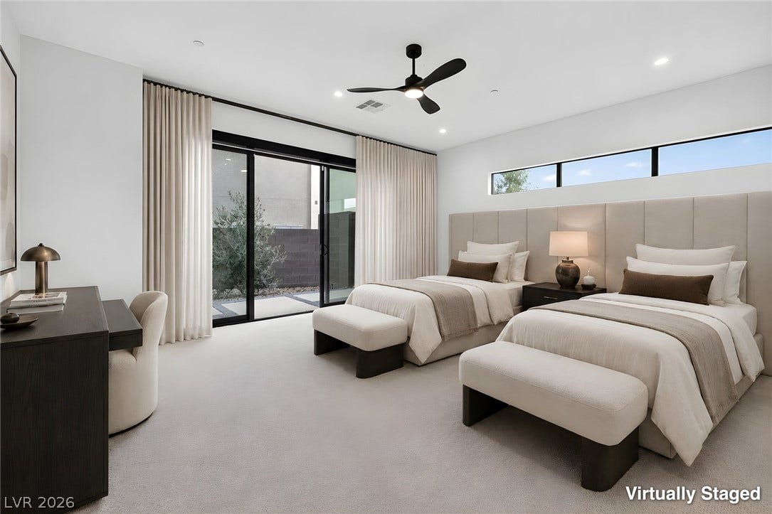 Sliding glass doors open to the outdoors, filling this modern bedroom with natural light.