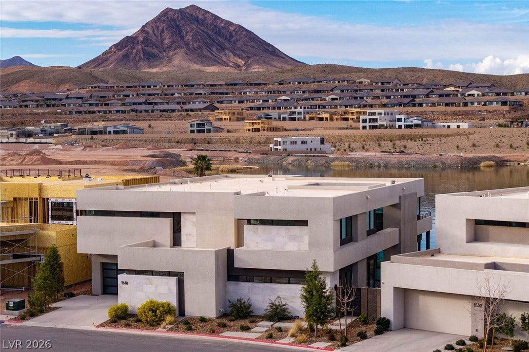 Striking contemporary architecture stands set against a majestic mountain backdrop.