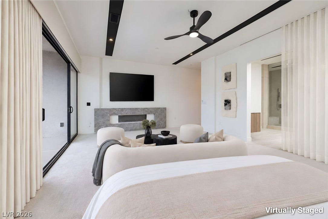 A spacious layout and sliding glass doors create an airy, modern master suite.