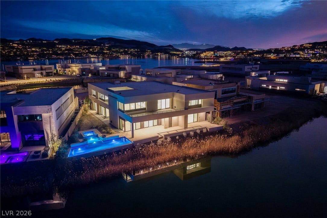 Dramatic modern architecture commands attention along the serene waters edge under twilight skies.