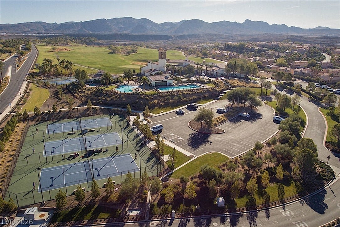 An aerial perspective showcases the resort-style community amenities set against a scenic mountain backdrop.