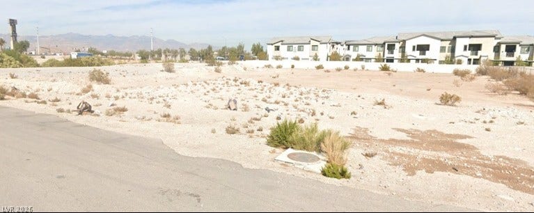 Bowes Avenue, Henderson, NV 89044 Distant mountains frame this open development site adjacent to paved roadway access.