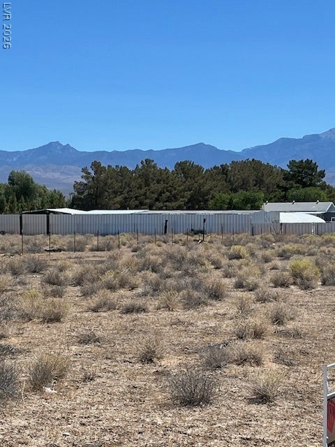801 S Ford Loop, Pahrump, NV 89048 Rugged terrain gives way to sweeping mountain ridges rising against a clear sky.