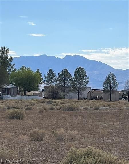 801 S Ford Loop, Pahrump, NV 89048 Majestic mountain ridges rise beyond a desert expanse, framing an open lot with scenic possibilities.