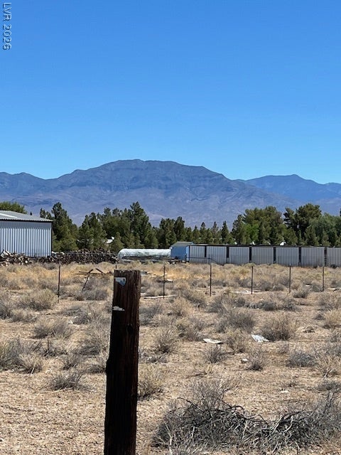 801 S Ford Loop, Pahrump, NV 89048 Dramatic mountain peaks rise in the distance beyond the natural desert landscape.