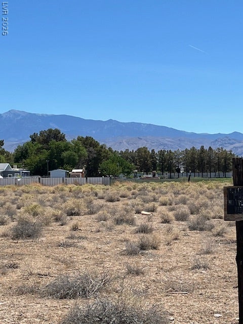 801 S Ford Loop, Pahrump, NV 89048 Expansive desert vistas stretch toward majestic mountain ranges under a clear blue sky.