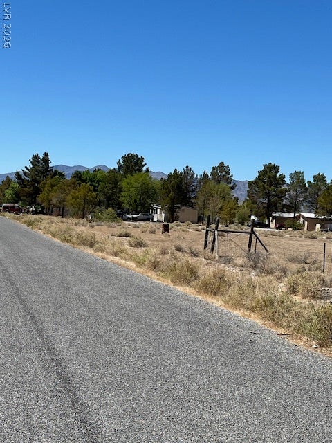 801 S Ford Loop, Pahrump, NV 89048 Mature trees line the roadside edge of this expansive mountain-view property.