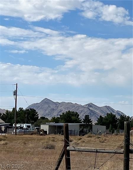 801 S Ford Loop, Pahrump, NV 89048 Rugged peaks frame the horizon beyond the open pastureland and outbuildings of this property.