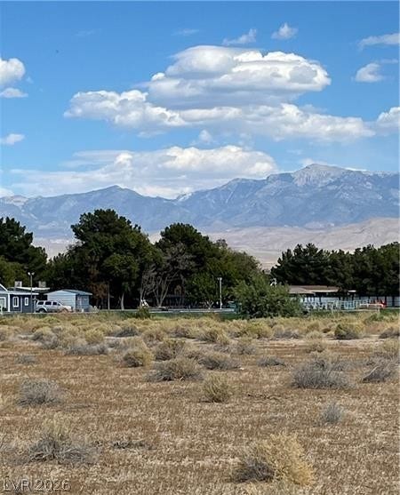 801 S Ford Loop, Pahrump, NV 89048 Majestic mountain ridges rise behind natural desert landscape under a clear blue sky.