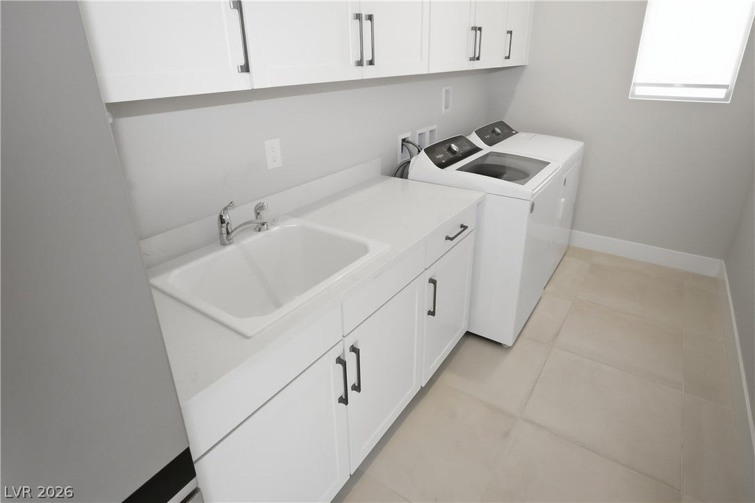 11164 Twisty Ridge Street, Las Vegas, NV 89183 A spacious utility area showcases solid surface countertops alongside a deep basins wash sink.