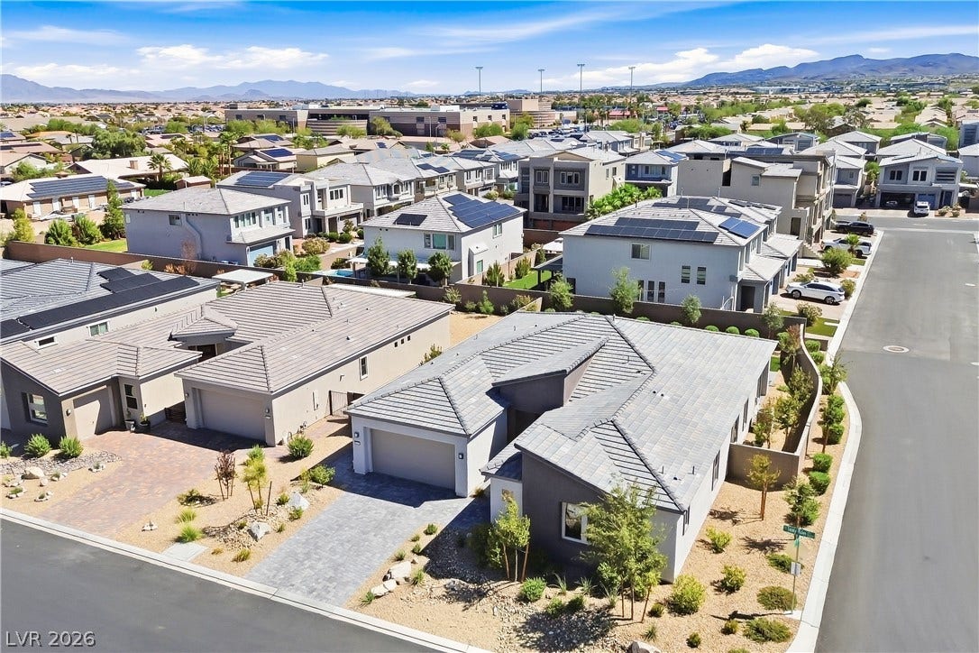 11164 Twisty Ridge Street, Las Vegas, NV 89183 An aerial perspective showcases modern residential architecture surrounded by scenic desert mountain vistas.