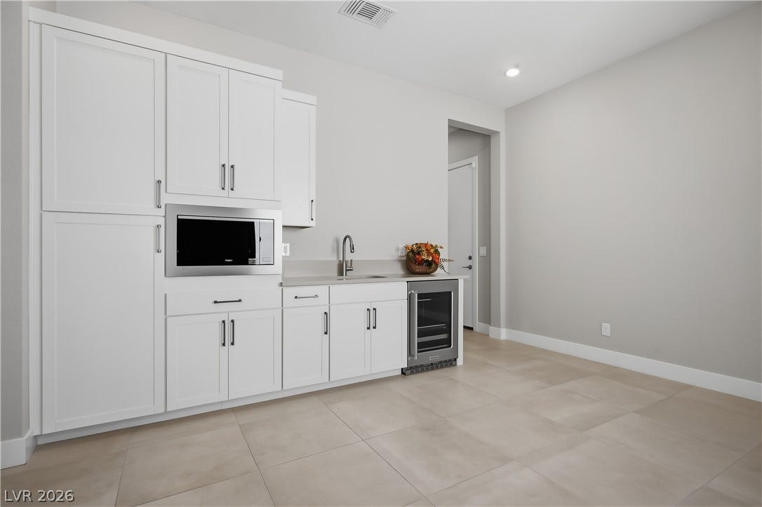 11164 Twisty Ridge Street, Las Vegas, NV 89183 Smooth tiled flooring complements streamlined cabinetry and built-in amenities in this functional space.