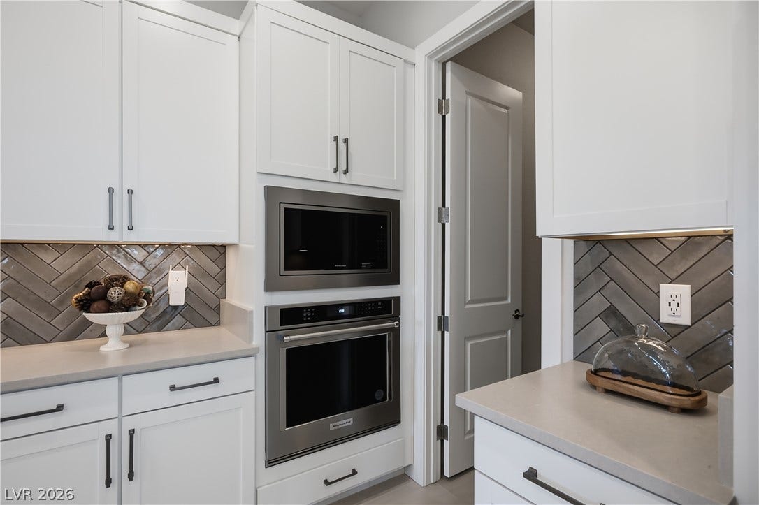11164 Twisty Ridge Street, Las Vegas, NV 89183 Gleaming built-in appliances integrate seamlessly with shaker cabinetry and a classic herringbone backsplash.