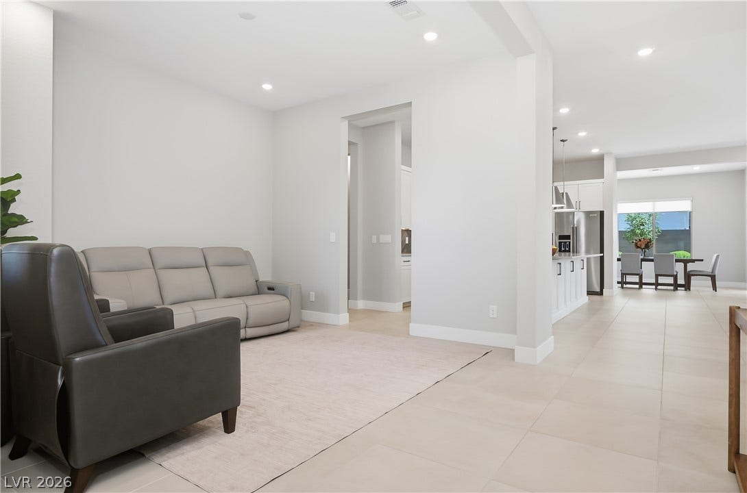 11164 Twisty Ridge Street, Las Vegas, NV 89183 Gleaming tile floors sweep through a modern, open-concept layout illuminated by recessed lighting.