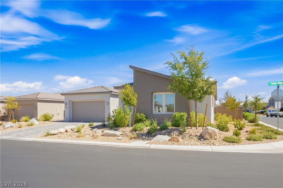 11164 Twisty Ridge Street, Las Vegas, NV 89183 Modern desert landscaping frames this contemporary home featuring clean lines and architectural style.