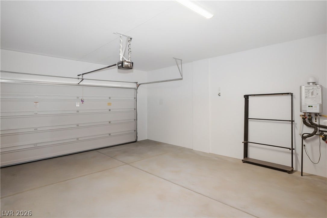 11164 Twisty Ridge Street, Las Vegas, NV 89183 Smooth concrete floors and freshly finished walls define this functional attached garage space.