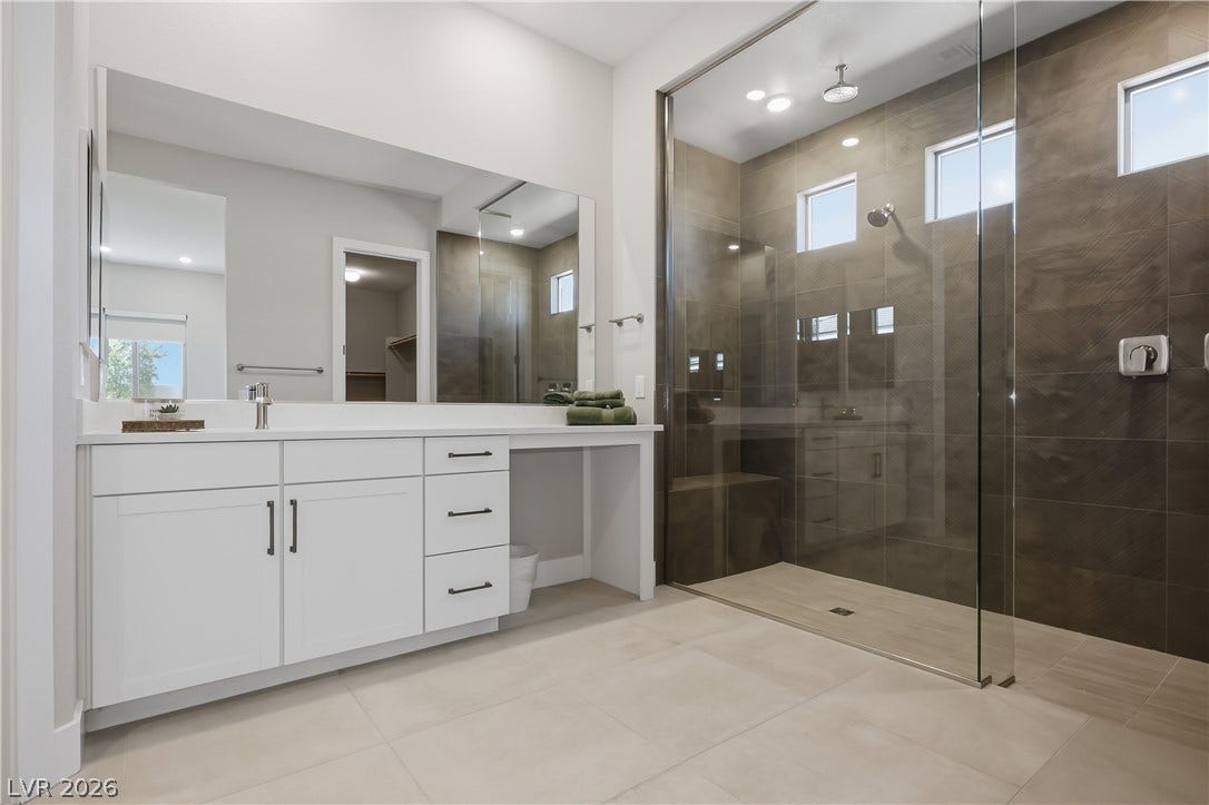 11164 Twisty Ridge Street, Las Vegas, NV 89183 Elegant tile floors and a glass-enclosed shower create a refined primary bath experience.