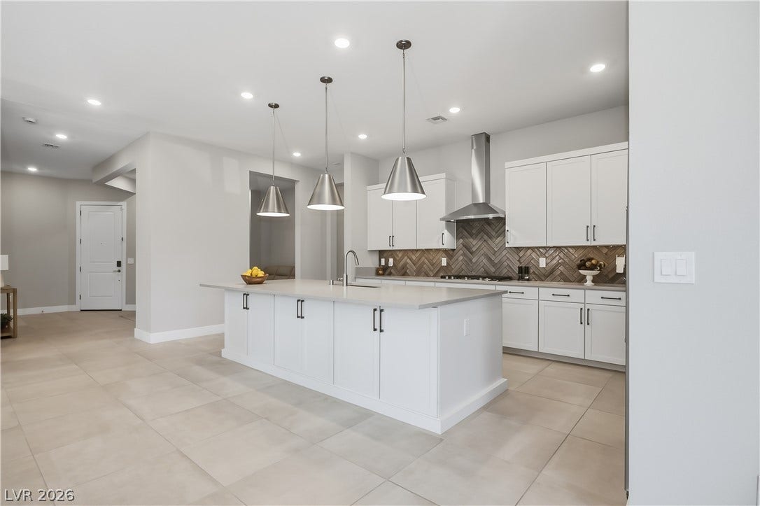 11164 Twisty Ridge Street, Las Vegas, NV 89183 An expansive central island grounds this contemporary culinary space defined by clean architectural lines.
