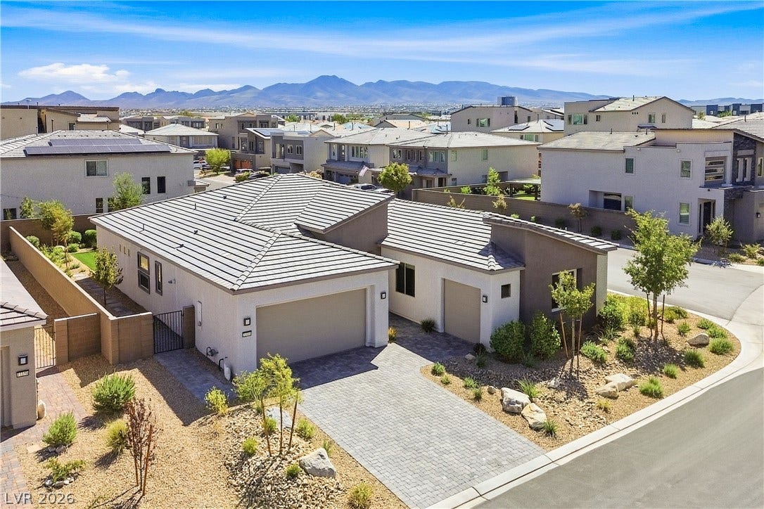 11164 Twisty Ridge Street, Las Vegas, NV 89183 A paved driveway leads to the garage of this modern home with mountain views.