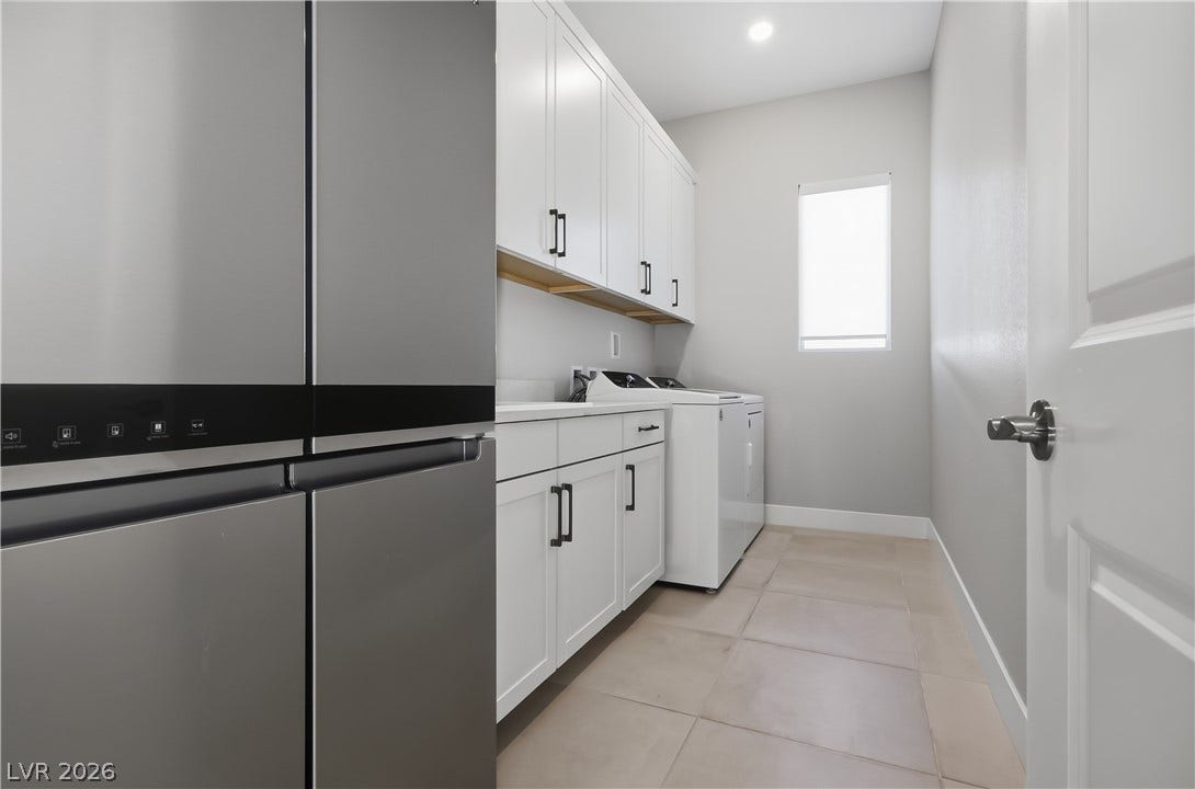 11164 Twisty Ridge Street, Las Vegas, NV 89183 Functional cabinetry and tile flooring define this dedicated laundry area.