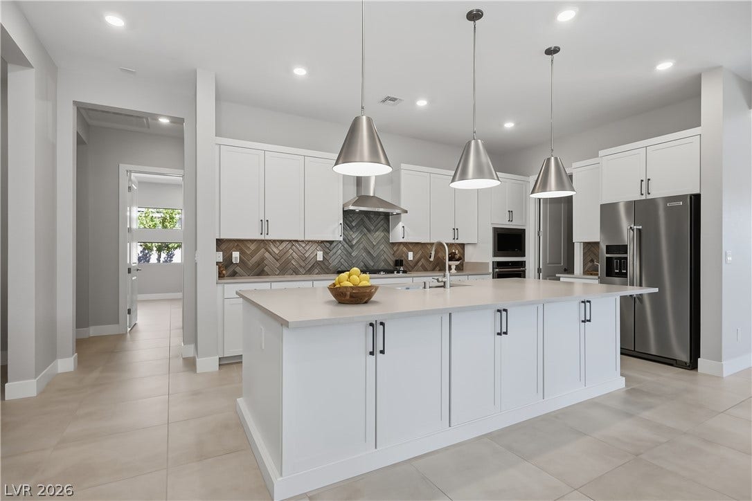 11164 Twisty Ridge Street, Las Vegas, NV 89183 Gleaming tile floors and a generous center island define this modern culinary workspace.