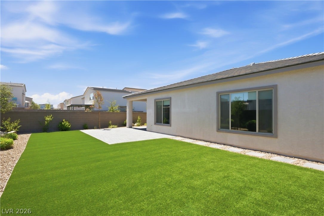 11164 Twisty Ridge Street, Las Vegas, NV 89183 A pristine lawn and paved patio space define this private backyard retreat.