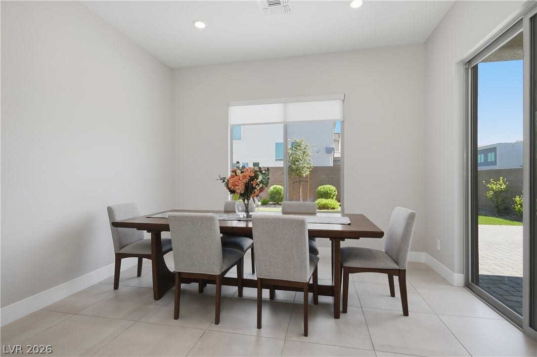 11164 Twisty Ridge Street, Las Vegas, NV 89183 Recessed lighting illuminates tiled flooring and glass doors opening to the outdoor space.
