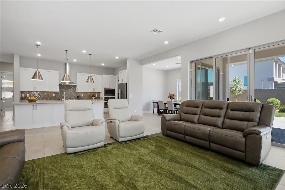 11164 Twisty Ridge Street, Las Vegas, NV 89183 An open floorplan seamlessly connects the living space to a modern kitchen and dining area.