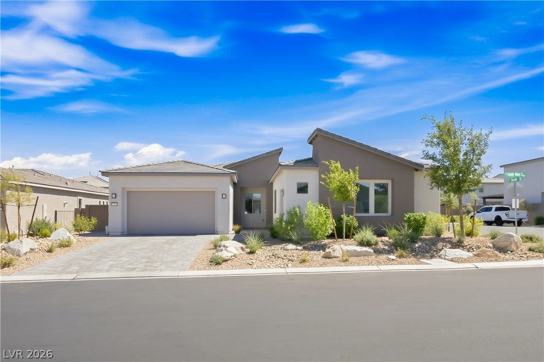 11164 Twisty Ridge Street, Las Vegas, NV 89183 Clean modern architectural lines define this single-story desert home featuring a paved driveway and low-maintenance landscaping.