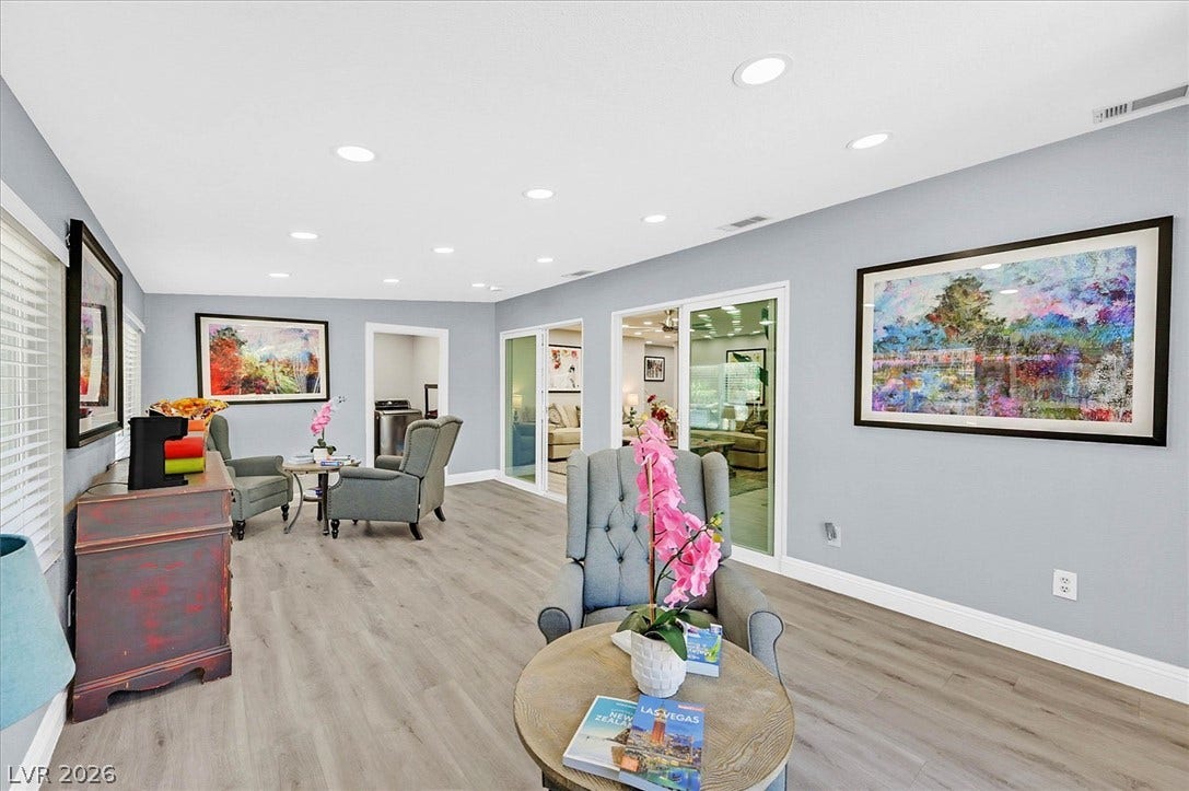 Recessed lighting illuminates this bright living space with durable vinyl plank flooring.