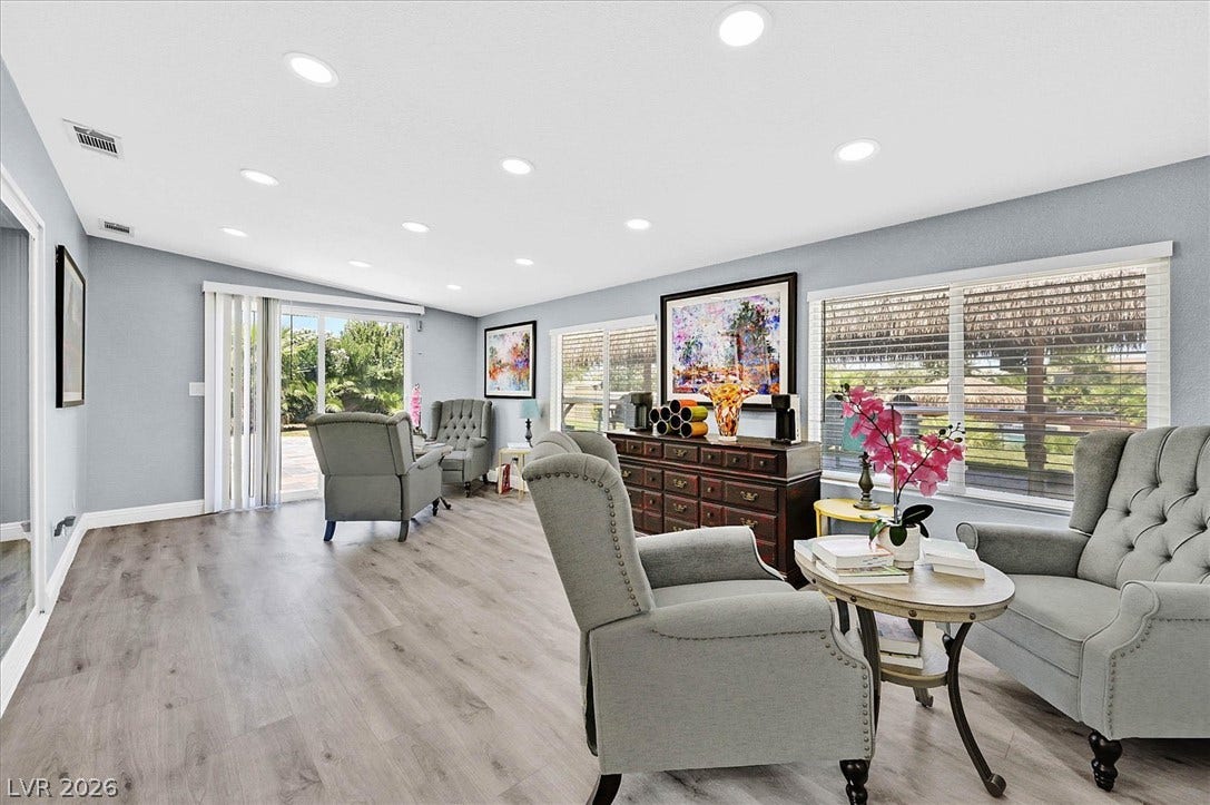 Recessed lighting illuminates this inviting living space, connecting seamlessly to outdoor areas through sliding glass doors.