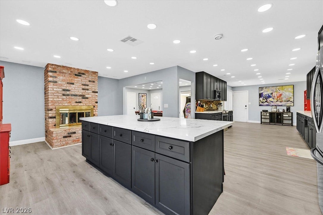 A spacious kitchen with a generously sized island, perfect for entertaining guests.