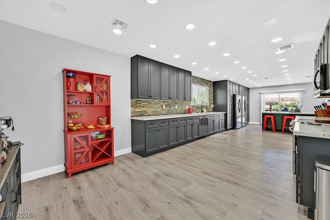 Long, well-lit kitchen with sleek cabinetry and durable flooring perfect for entertaining.