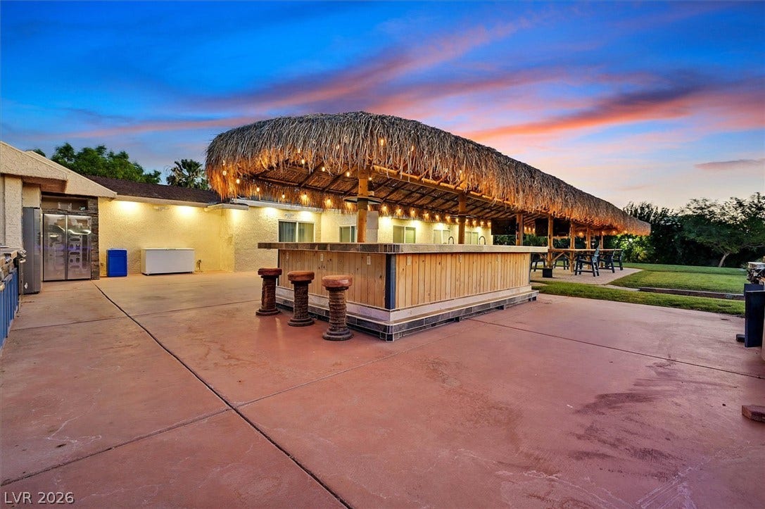 An inviting outdoor bar area, perfect for entertaining under a captivating twilight sky.